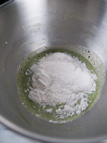 Flour added into mixture of matcha hot cross buns