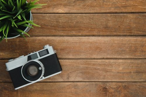 Camera on brown wood backdrop